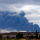 Billowing smoke from the Sesena fire is seen from a distance.